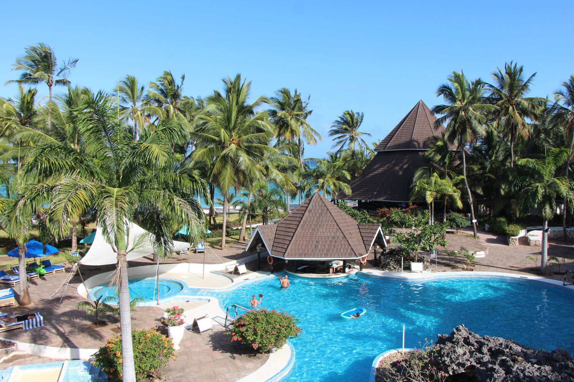 Beachfront resort pool among palm trees on the Kenya coast