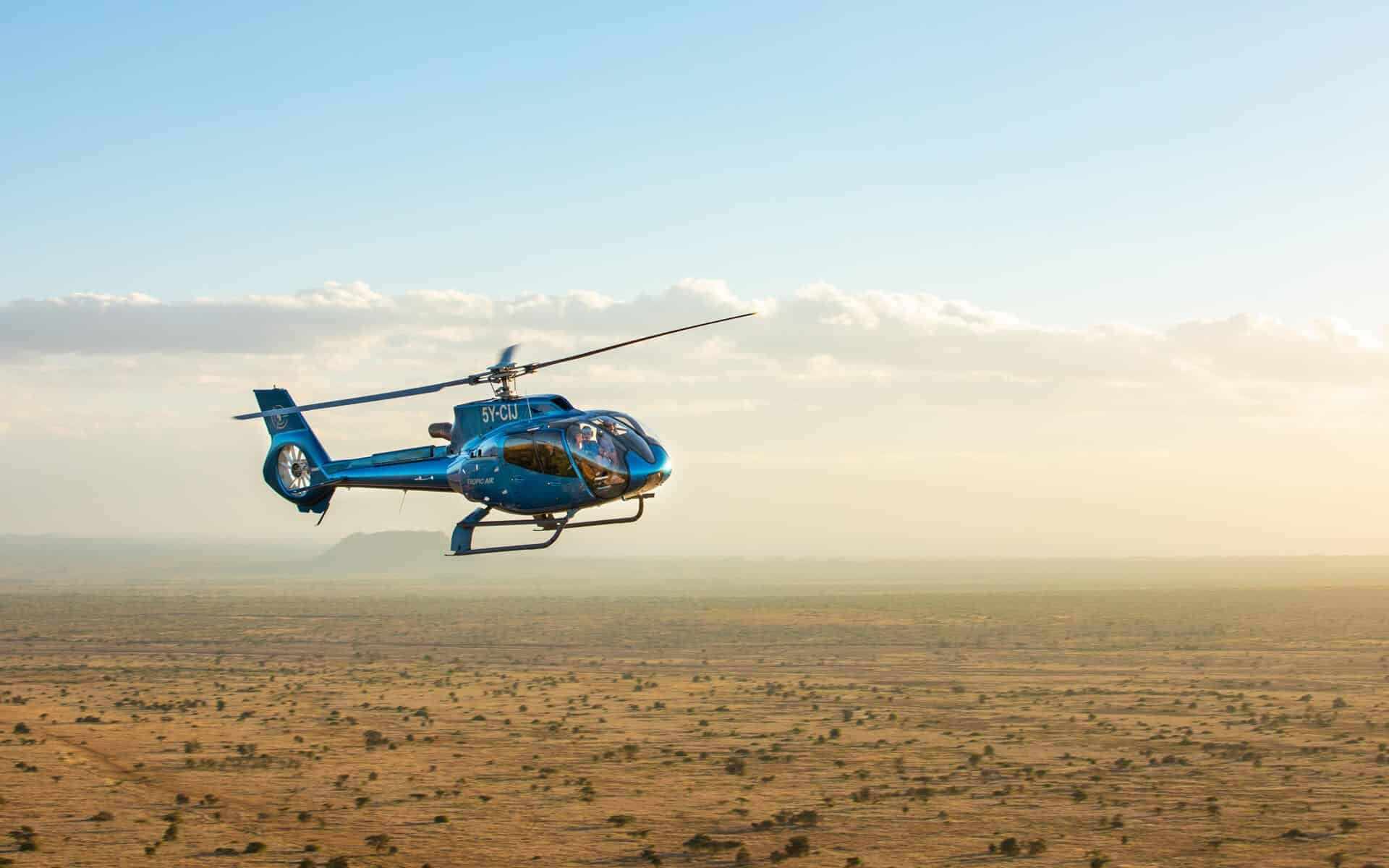 Helicopter flying low over the Kenyan plains on a flying safari