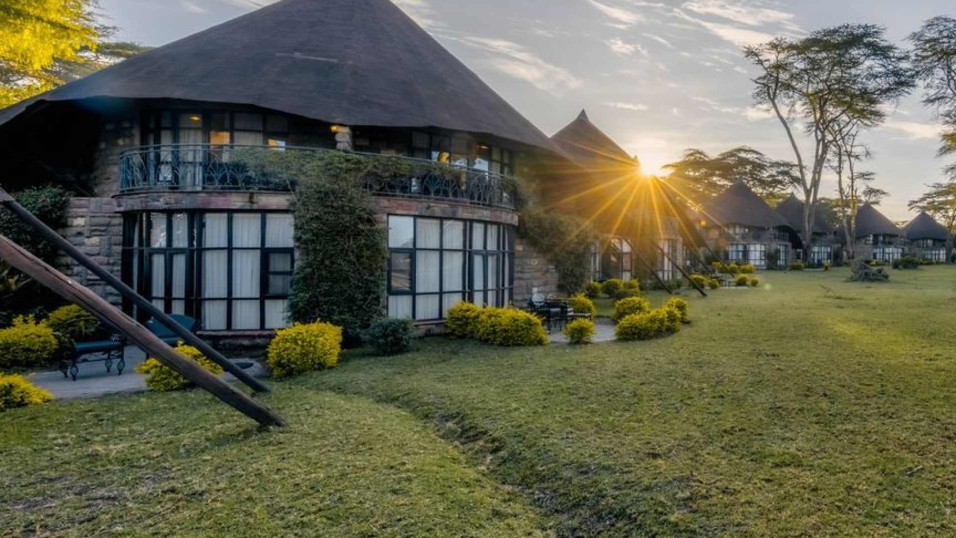 Thatched lakeside resort and gardens at sunset on Lake Naivasha