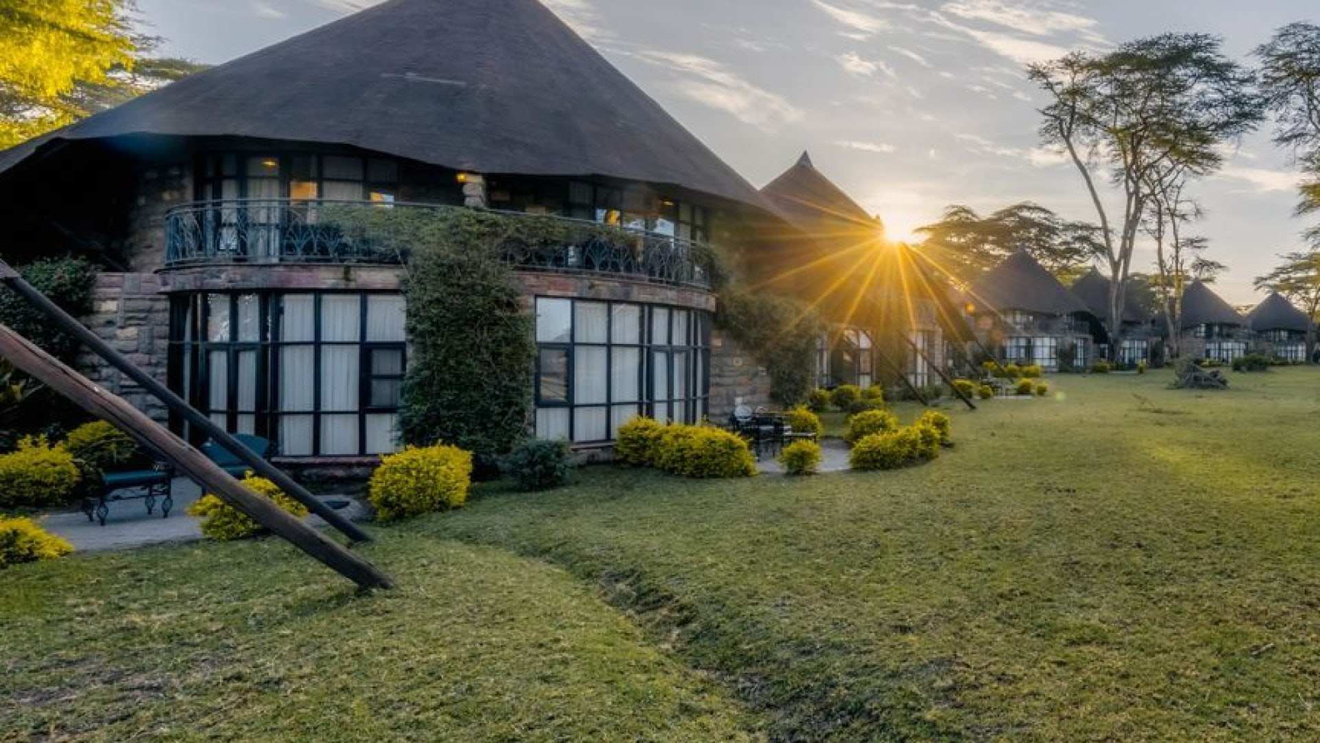 Thatched lakeside resort and gardens at sunset on Lake Naivasha